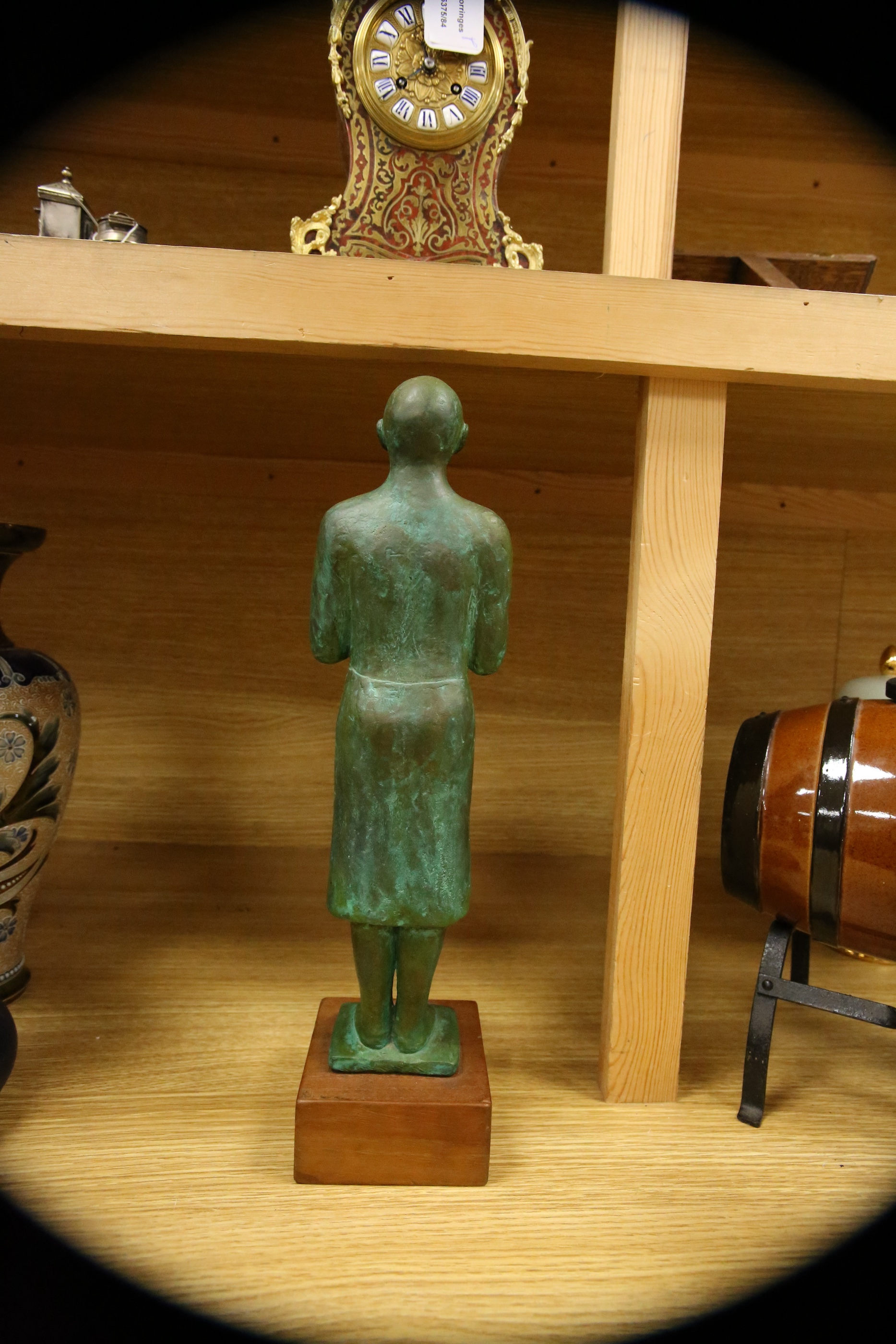 A figural bronze of an Oriental gentleman in prayer, height 42cm including stand. Condition - good